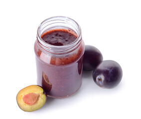 Glass jar with delicious homemade plum jam on white background