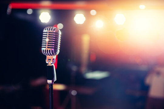 Close-up old retro vintage microphone on tinted color background copy space