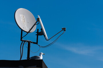 satellite dishes on the roof, blue sky