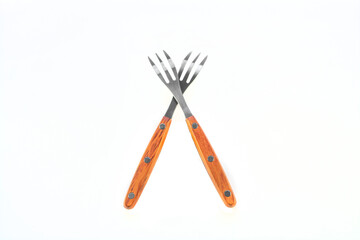 Two crossed forks on a white background