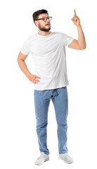 Fototapeta premium Portrait of young man showing something on white background