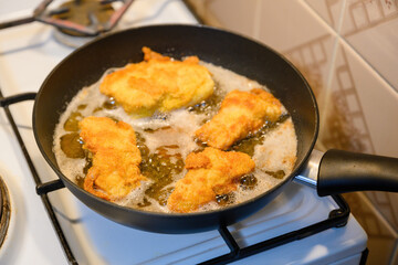Close-up on frying cutlets in a pan.