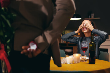 African-American man greeting his girlfriend on Valentine's Day at home