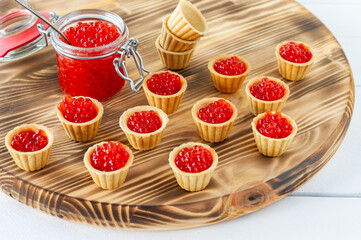 Tartlets with butter and red caviar. Gourmet food, appetizer. Delicatessen. Seafood.
