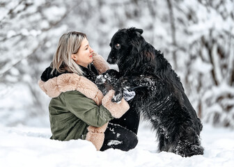 Beautiful woman play with a dog,