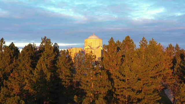Durdevi Stupovi Monastery Behind Woods At Sunset In City Of Novi Pazar, Raska, Serbia. - aerial, reveal