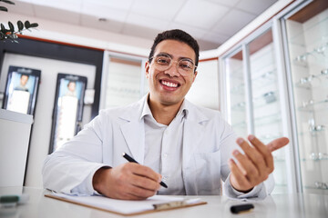 Smiling ophthalmologist with a pen in his hand