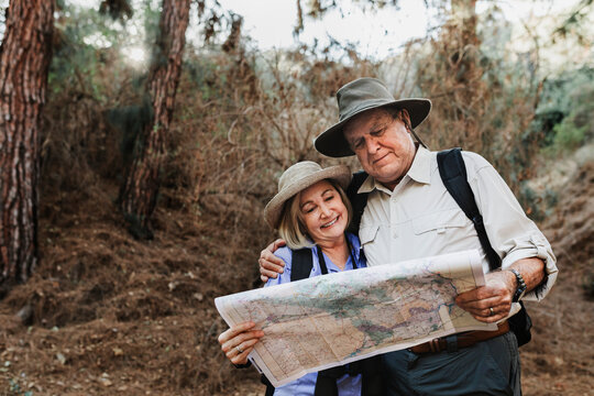 Lovely senior couple using a map to search for direction