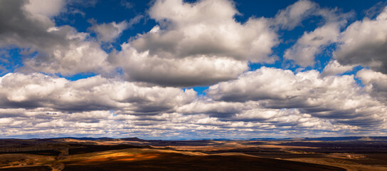 blue sky with clouds above the steppe