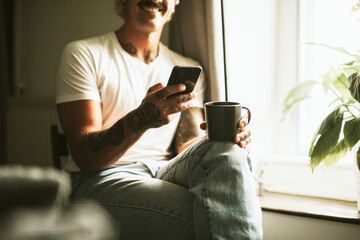 Urban man in white using digital mobile phone