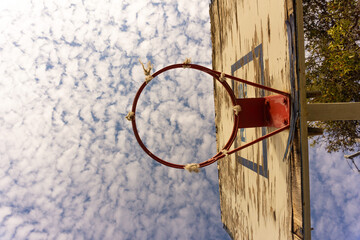 The sky and Old basketball board without net