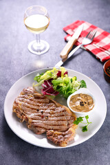 fried beef fillet with sauce and lettuce
