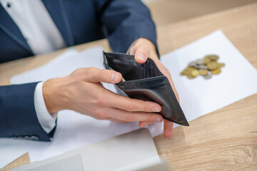 Hands of man in suit with open wallet