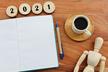 Business concept of top view 2021 with empty notebook over wooden desk