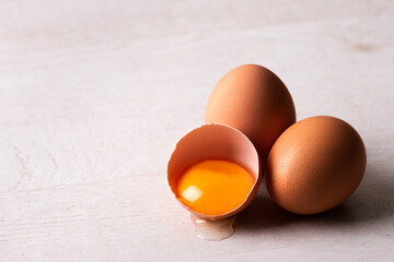 raw chicken eggs on a wooden background. Close-up view.