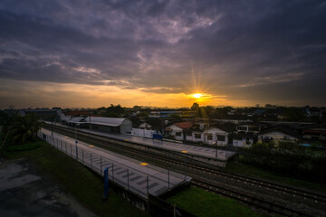 Fototapeta na wymiar Selective focus on sunrise view with railway train station and orange sunray. 
