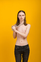 Feminine young man with metal chain. Slender body
