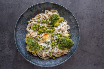 healthy baked green spaghetti pasta with feta cheese