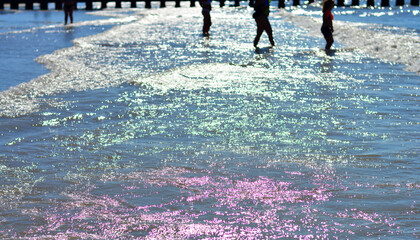 the sun sets on the waves of the sea