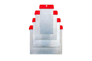 A set of metallic putty knives different sizes with flexible blades isolated in the white background