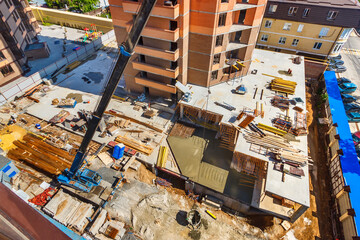 The top down view of a construction site of a modern multistory residential building