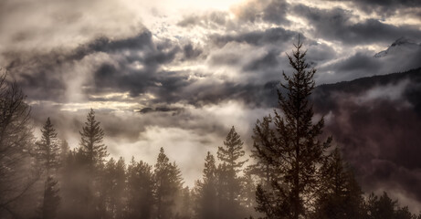 Dramatic Scenic Nature Panoramic View of Canadian Mountain Landscape covered in clouds. Artistic Render. Located near Squamish and Whistler, British Columbia, Canada.