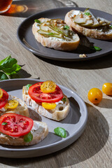 Sandwiches on plates, bright sunlight.