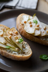 Bruschetta with curd cheese, pear and pine nuts.