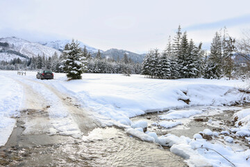 ZAKOPANE, POLAND - JANUARY 28, 2021: Banks of a mountain stream covered with snow, winter landscape.