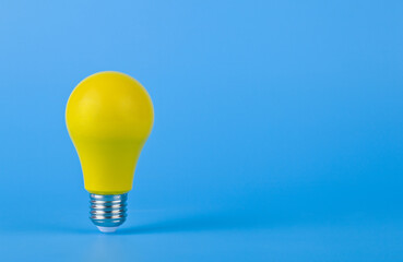 Yellow lamp on a blue background close-up.