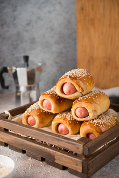 Home sausage baked in pastry with sesame, homemade food, copy space