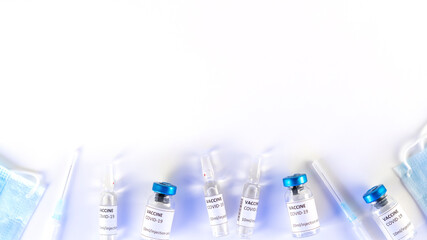 Coronavirus vaccine background with copy space. Covid-19 vaccination with vaccine vials. Syringe injection for corona immunization treatment. Thanks to the vaccine, the pandemic will end. Top view.