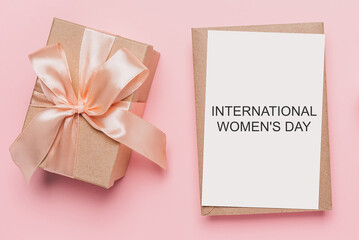 Gifts with note letter on isolated pink background, love and valentine concept with text International Womens Day
