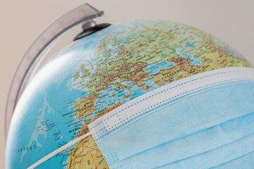 Globe with face protecting mask.  Coronavirus pandemic concept.