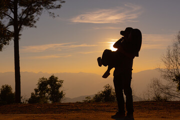 Young couple enjoying the sunset in the mountain