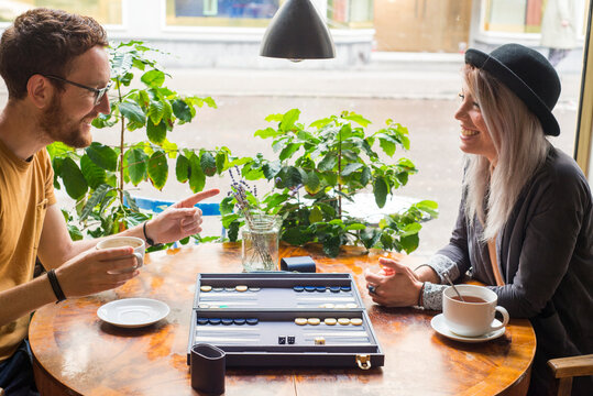 Couple playing backgammon in cafe