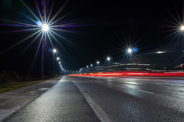 Car light trail and city light. Night shot. Vehicle back lights illumination on highway