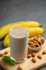 Banana almond smoothie on dark background