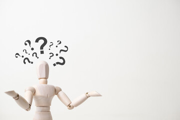wooden mannequin with doubtful gesture on white background - confusion and asking question concept