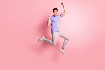 Fototapeta na wymiar Full size photo of young excited man happy smile jump rejoice victory success fists hands isolated over pastel color background