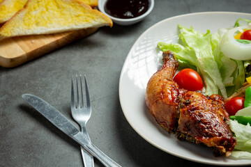 Grilled chicken steak and vegetables on dark background