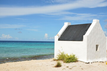 Historical picture on the caribbean island of Bonaire, Antilles, slave houses on the beach.