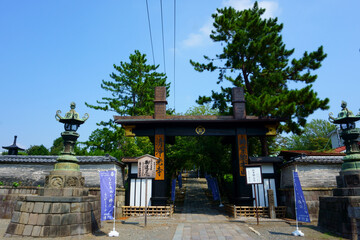 Fujisawa / Japan. Yugyo-ji Temple. So-mon Gate is a kabuki gate, which has two pillars connected with a horizontal beam (kabuki), and also called Kuro-mon (Black Gate)