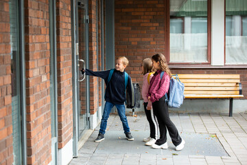 Children opening school door