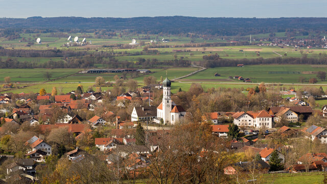 View on the town of Pähl with church St. Laurentius. In the background the satellite dishes of Raisting.