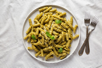Homemade Pesto Twist Pasta on a plate, top view. Overhead, from above, flat lay.