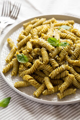 Homemade Pesto Twist Pasta on a plate, side view.