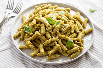Homemade Pesto Twist Pasta on a plate, side view. Close-up.
