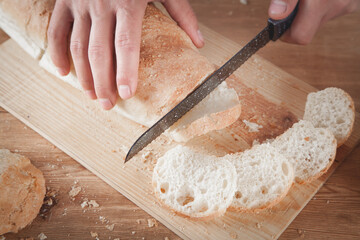 Caucasian man cutting bread. Healthy food