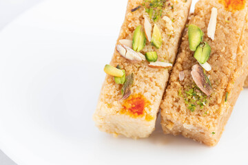 Delicious Mithai Hot Milkcake Kalakand Burfi Or Alwar Ka Mawa Barfi Made Of Khoya Doodh Malai Decorated With Badam Or Badaam Nuts Kaju And Pista. Isolated On White Background With Space For Text